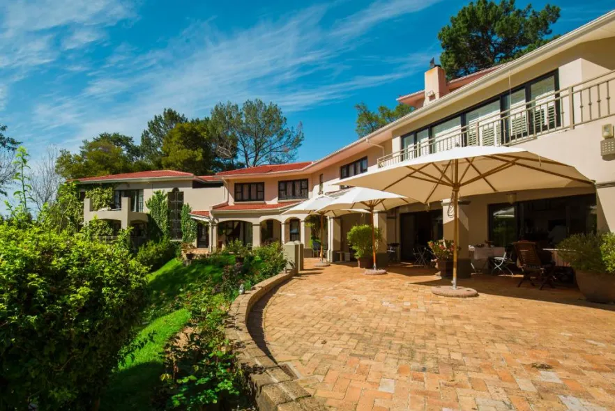 Southern Light's brick terrace and parasols beside the garden