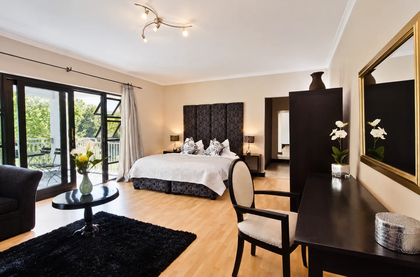 Example guest bedroom with garden-facing doors at Southern Light